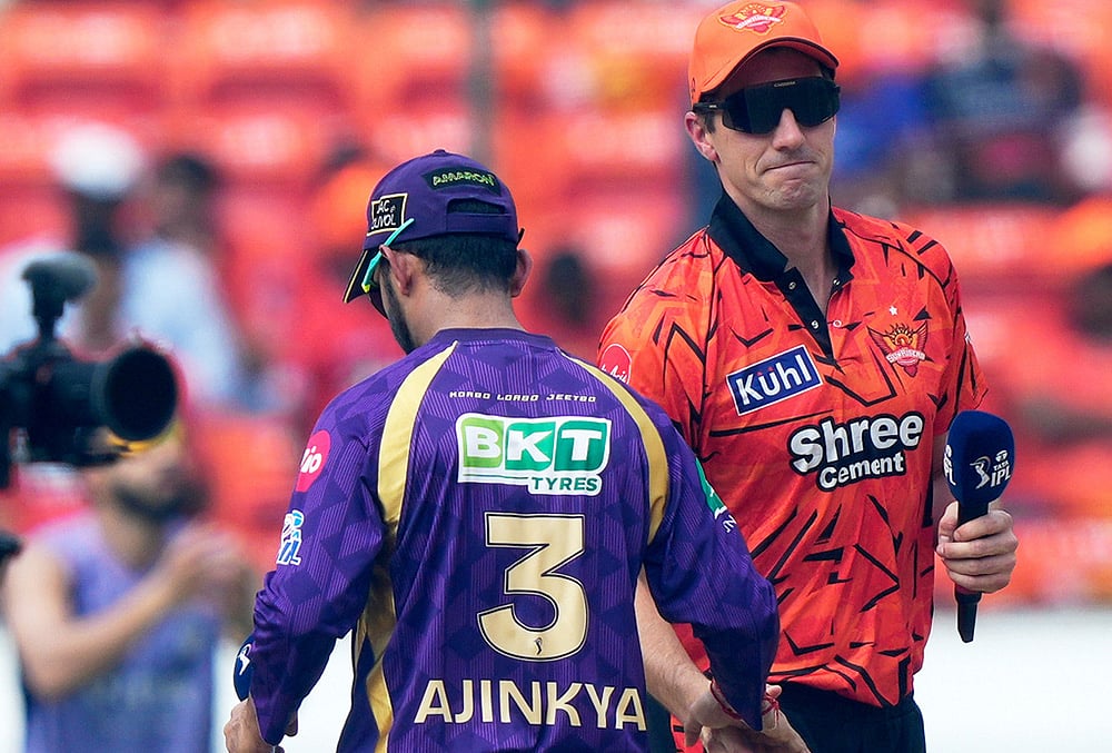 Sunrisers Hyderabad's Pat Cummins, right and Kolkata Knight Riders' captain Ajinkya Rahane shake hands after the coin toss during the Indian Premier League cricket match between Sunrisers Hyderabad. - | Photo: AP/Mahesh Kumar A.