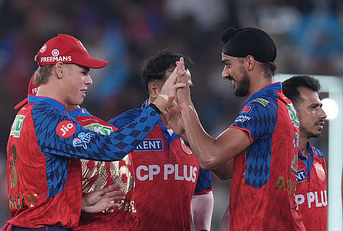 Punjab Kings' Arshdeep Singh celebrates the wicket of Gujarat Titans' captain Shubman Gill during the Indian Premier League cricket match between Gujarat Titans and Punjab Kings in Ahmedabad.