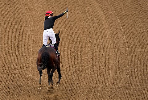 Jockey Jose L. Ortiz celebrates after riding Golden Tempo to victory the 152nd running of the Kentucky Derby horse race at Churchill Downs, in Louisville, Kentucky.