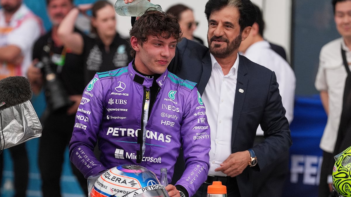 Mohammed Ben Sulayem President of the Federation Internationale de l'Automobile (FIA) pours water on the head of Mercedes driver Kimi Antonelli of Italy after Antonelli won the Miami Formula One Grand Prix auto race. - AP Photo