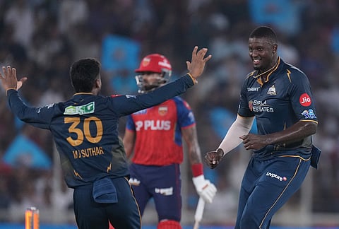 Gujarat Titans' Jason Holder, right, celebrates the wicket of Punjab Kings' captain Shreyas Iyer during the Indian Premier League cricket match between Gujarat Titans and Punjab Kings in Ahmedabad.