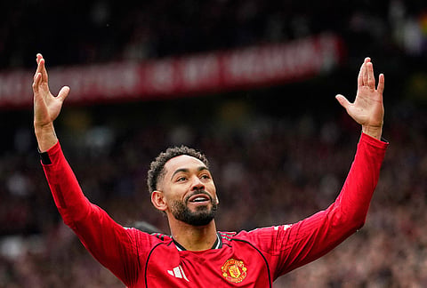 Manchester United's Matheus Cunha celebrates after scoring his side's opening goal during the English Premier League soccer match between Manchester United and Liverpool in Manchester, England.