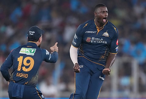 Gujarat Titans' Jason Holder, right, celebrates the wicket of Punjab Kings' Nehal Wadhera during the Indian Premier League cricket match between Gujarat Titans and Punjab Kings in Ahmedabad.