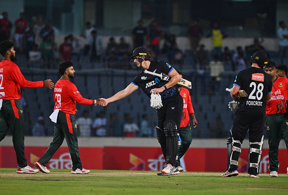 New Zealand's Bevon Jacobs shakes hands with Bangladesh's players after winning the third T20 international cricket match between Bangladesh and New Zealand in Mirpur, Bangladesh. - | Photo: AP/Mosaraf Hossain