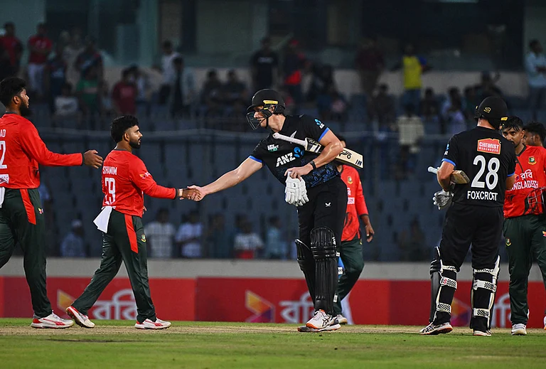 New Zealand's Bevon Jacobs shakes hands with Bangladesh's players after winning the third T20 international cricket match between Bangladesh and New Zealand in Mirpur, Bangladesh. - | Photo: AP/Mosaraf Hossain