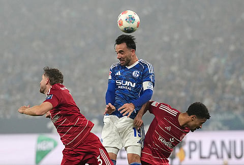 Schalke's Kenan Karaman, center, heads the ball during the German Bundesliga 2 soccer match between FC Schalke 04 and Fortuna Duesseldorf in Gelsenkirchen, Germany.
