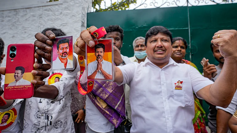 Supporters hold portraits of Tamilaga Vettri Kazhagam (TVK) chief Vijay during vote tabulation on the day of Assembly election results, in Chennai, Monday, May 4, 2026. - Photo: PTI