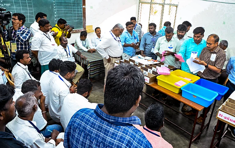 Poll officials during the counting of votes for the Puducherry Assembly elections at a counting centre, in Puducherry. - PTI