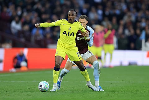 Aston Villa's Matty Cash, right, and Tottenham's Mathys Tel battle for the ball during the English Premier League soccer match between Aston Villa and Tottenham Hotspur in Birmingham, England.