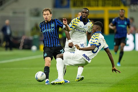 Inter Milan's Nicolo Barella, left, challenges for the ball with Parma's Abdoulaye Ndiaye during a Serie A soccer match between Inter Milan and Parma, in Milan, Italy.