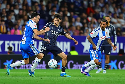 Espanyol's Edu Exposito, left, and Real Madrid's Thiago Pitarch Pinar fight for the ball during the La Liga soccer match between Espanyol and Real Madrid in Barcelona Spain.