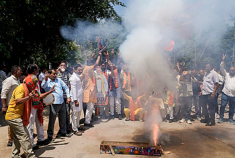 BJP supporters celebrate during vote tabulation on the day of Assembly election results across five states, at BJP headquarters, in New Delhi.