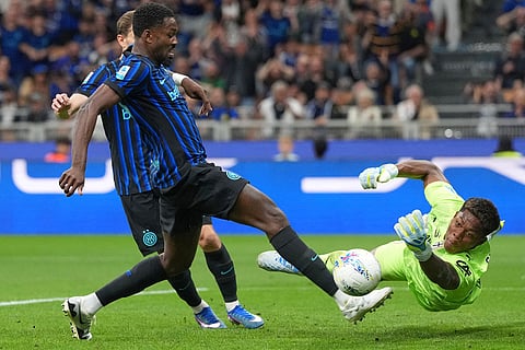 Parma's goalkeeper Zion Suzuki, right, makes a save against of Inter Milan's Marcus Thuram during a Serie A soccer match between Inter Milan and Parma, in Milan, Italy.