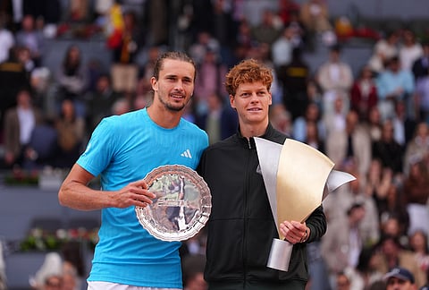 Jannik Sinner, of Italy, right, is flanked by Alexander Zverev, of Germany, after winning the men's singles tennis final match at the Madrid Open tennis tournament in Madrid, Spain.