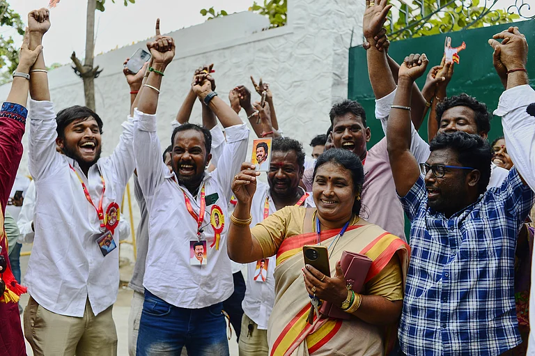 TVK workers hold photographs of their leader, actor-turned-politician Vijay Chandrasekhar, as they celebrate early leads and results in the recently held state election, in Chennai, southern Indian state of Tamil Nadu. - PTI