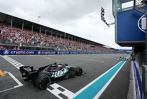 Mercedes driver Kimi Antonelli, of Italy, finishes first in the Miami Formula One Grand Prix auto race as former tennis player Rafael Nadal, bottom right, waves a checkered flag Sunday, May 3, 2026, in Miami Gardens, Florida. Former tennis player Rafael Nadal, bottom right, waves a checkered flag.