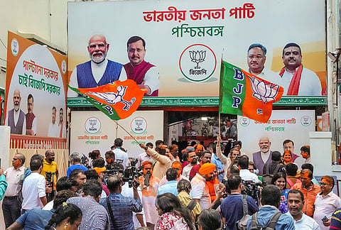 BJP supporters celebrate party's lead during vote tabulation on the day of West Bengal Assembly election results, at party office, in Kolkata.