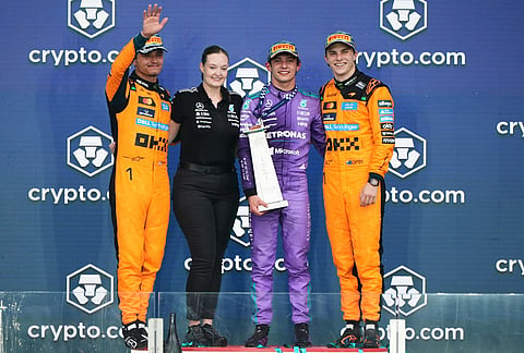 Second-place finisher McLaren driver Lando Norris, left, of Britain; first-place finisher Mercedes driver Kimi Antonelli, second from right, of Italy; and third-place finisher McLaren driver Oscar Piastri, right, of Australia, stand on the winners' podium after the Miami Formula One Grand Prix auto race, in Miami Gardens, Florida. 
