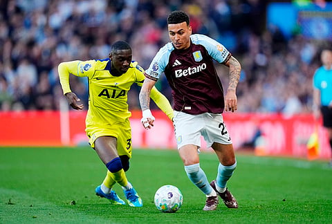 Aston Villa's Morgan Rogers, right, and Tottenham Hotspur's Randal Kolo Muani  during the English Premier League soccer match between Aston Villa and Tottenham Hotspur in Birmingham, England.