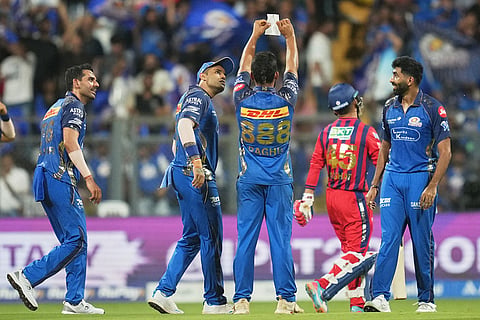 Mumbai Indian's Raghu Sharma celebrates with teammates the wicket of Lucknow Super Giants' Akshat Raghuwanshi during the Indian Premier League cricket match between Mumbai Indians and Lucknow Super Giants in Mumbai, India.