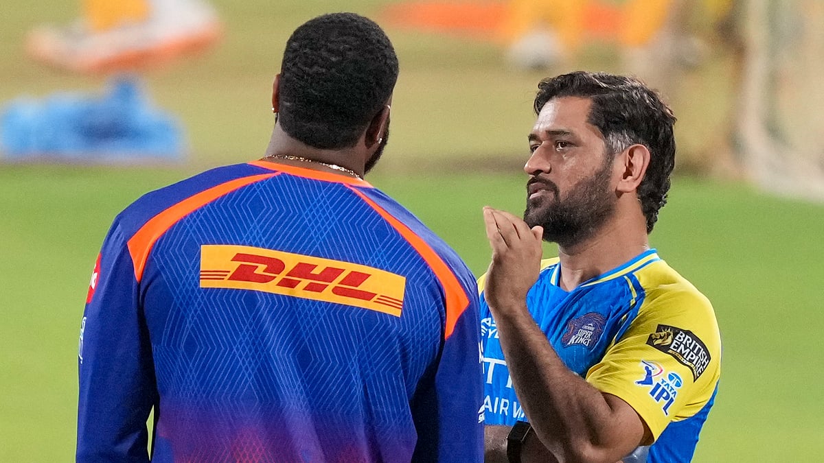 Mumbai Indians' batting coach Kieron Pollard, left, with Chennai Super Kings' MS Dhoni during a training session ahead of an Indian Premier League match in Chennai. - PTI