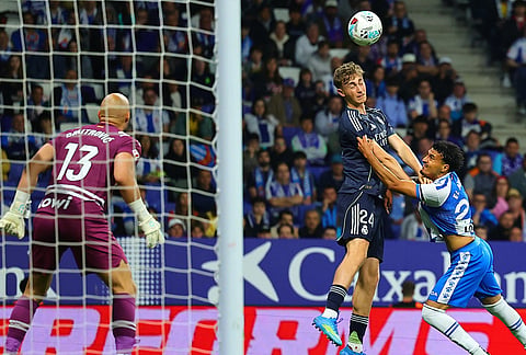 Real Madrid's Dean Huijsen, left, and Espanyol's Omar El Hilali fight for the ball during the La Liga soccer match between Espanyol and Real Madrid in Barcelona Spain.