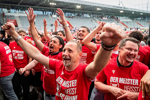 Thun head coach Mauro Lustrinelli, centre, assistant coach Nelson Ferreira, left, and sporting director Dominik Albrecht, right, celebrate the championship title in Thun, Switzerland.