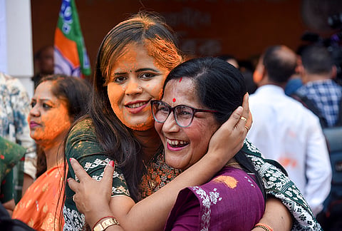 BJP workers celebrate as the party takes leads during the Assam Assembly elections results day, at party headquarters, in Guwahati.