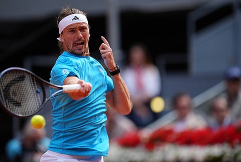 Alexander Zverev, of Germany, returns the ball to Jannik Sinner, of Italy, during their men's singles tennis final match at the Madrid Open tennis tournament in Madrid, Spain.