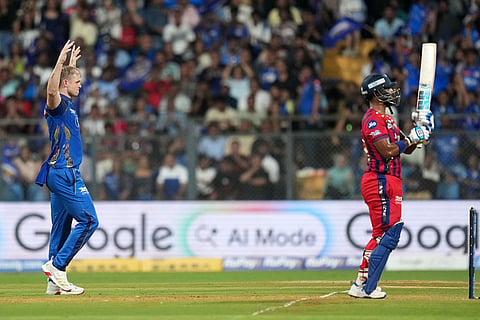 Mumbai Indians' Corbin Bosch celebrates the wicket of Lucknow Super Giants' Nicholas, right, Pooran during the Indian Premier League cricket match between Mumbai Indians and Lucknow Super Giants in Mumbai, India.