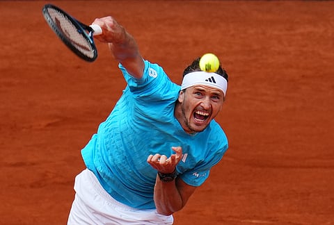 Alexander Zverev, of Germany, serves the ball to Jannik Sinner, of Italy, during their men's singles tennis final match at the Madrid Open tennis tournament in Madrid, Spain.