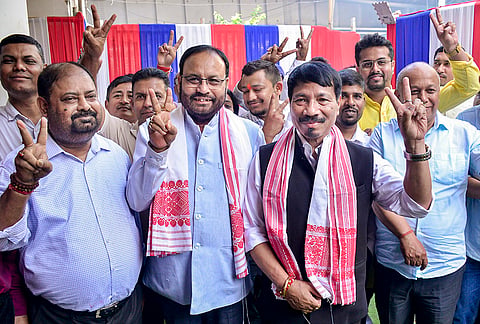 Asom Gana Parishad (AGP) President Atul Bora with party Working President Keshab Mahanta and other party leaders show victory sign after their party wins in Assam Assembly elections, at party headquarters, in Guwahati. AGP has won 10 seats in the Assam Assembly elections. 