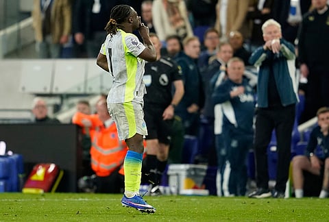 Manchester City's Jeremy Doku celebrates after scoring during the Premier League soccer match between Manchester City and Everton in Liverpool, England.