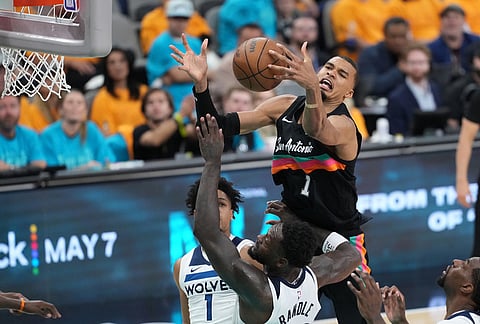 San Antonio Spurs forward Victor Wembanyama (1) reaches for the ball as Minnesota Timberwolves forward Julius Randle (30) defends during the second half in Game 1 of a second-round NBA playoffs basketball series in San Antonio.