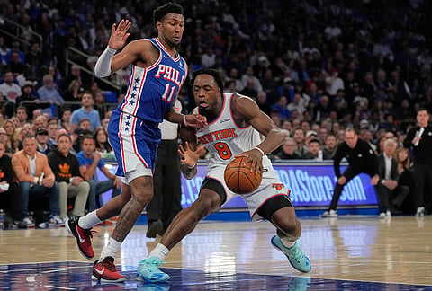 New York Knicks' Og Anunoby, right, drives past Philadelphia 76ers' Justin Edwards during the first half of Game 1 in a second-round NBA basketball playoffs series in New York. 