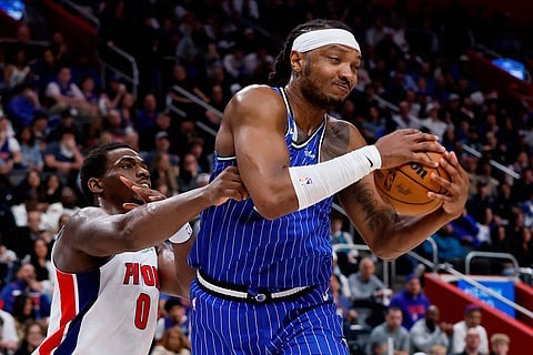 Orlando Magic center Wendell Carter Jr., right, beats Detroit Pistons center Jalen Duren (0) to a rebound during the first half in Game 7 of a first-round NBA basketball playoffs series in Detroit. 