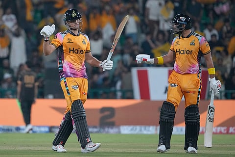 Peshawar Zalmi's Aaron Hardie, left, celebrates after scoring fifty during the Pakistan Super League final cricket match between Peshawar Zalmi and Hyderabad Kingsmen, in Lahore, Pakistan.