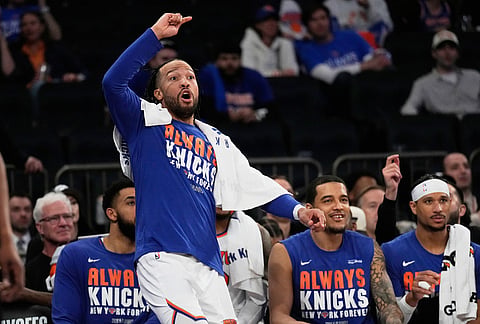 New York Knicks' Jalen Brunson reacts while watching from the bench during the second half of Game 1 in a second-round NBA basketball playoffs series against the Philadelphia 76ers in New York. 