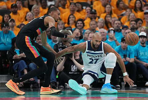 Minnesota Timberwolves center Rudy Gobert (27) loses control of the ball as San Antonio Spurs forward Victor Wembanyama (1) defends during the first half in Game 1 of a second-round NBA playoffs basketball series in San Antonio.
