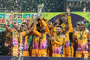 Photo: AP/K.M. Chaudary : Players of Peshawar Zalmi celebrates as they pose for photo with trophy after winning the Pakistan Super League final cricket match against Hyderabad Kingsmen, in Lahore, Pakistan.