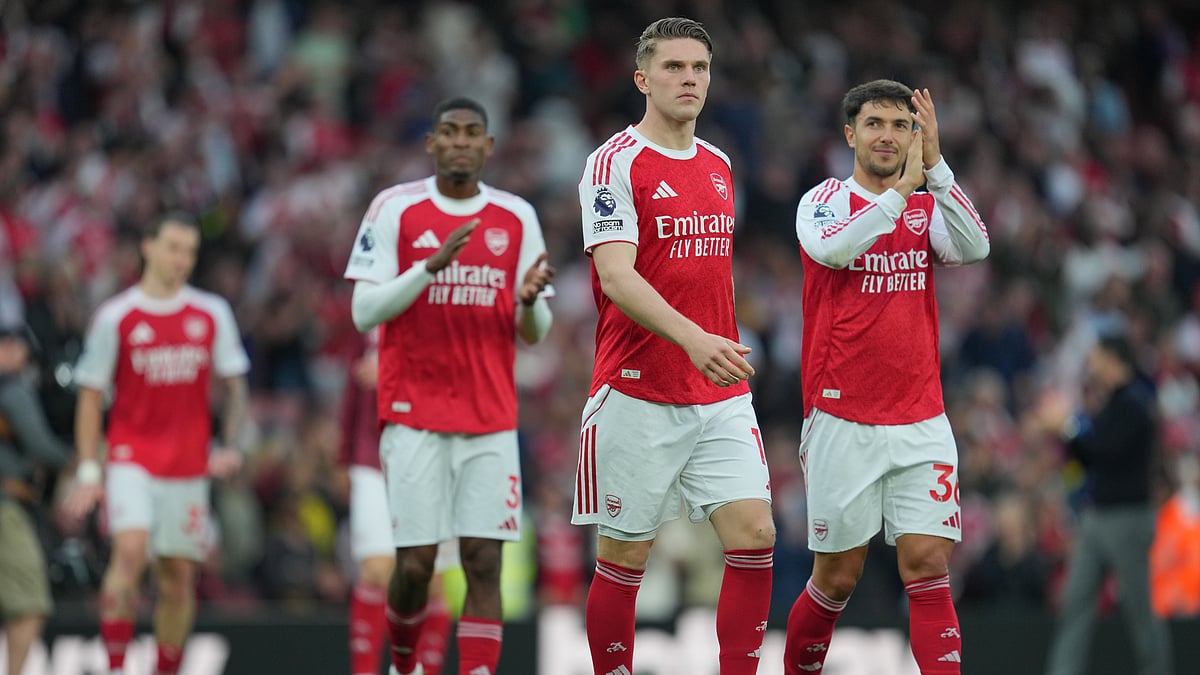 Arsenal players celebrate their victory at the English Premier League soccer match between Arsenal and Fulham in London, England. - AP Photo