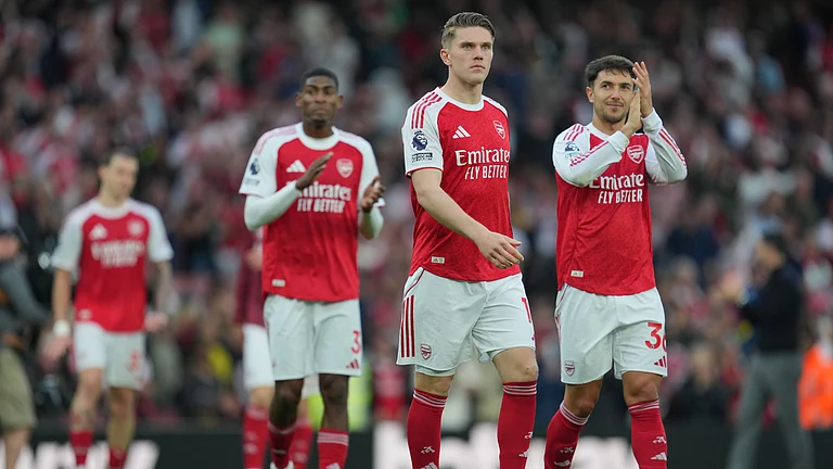 Arsenal players celebrate their victory at the English Premier League soccer match between Arsenal and Fulham in London, England. - AP Photo