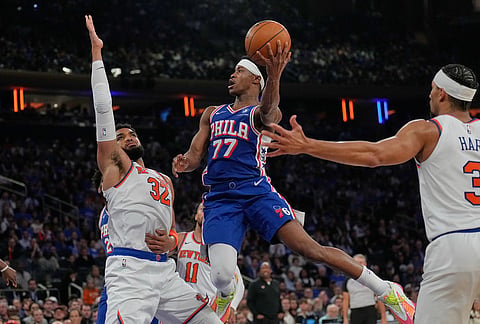 Philadelphia 76ers' Vj Edgecombe, center, drives to the basket during the second half of Game 1 in a second-round NBA basketball playoffs series against the New York Knicks in New York.