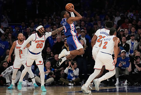 Philadelphia 76ers' Tyrese Maxey, center, goes up for a shot during the first half of Game 1 in a second-round NBA basketball playoffs series against the New York Knicks in New York. 