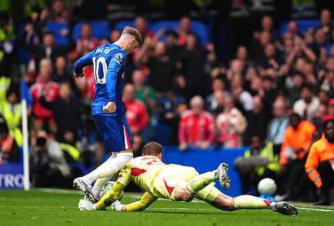 Nottingham Forest goalkeeper Matz Sels, right, claims the ball from Chelsea's Cole Palmer after he missed penalty kick during the English Premier League soccer match between Chelsea and Nottingham Forest in London.