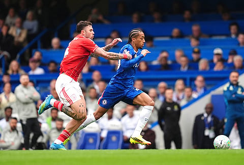 Nottingham Forest's Morato, left, and Chelsea's Joao Pedro battle for the ball during the English Premier League soccer match between Chelsea and Nottingham Forest in London.