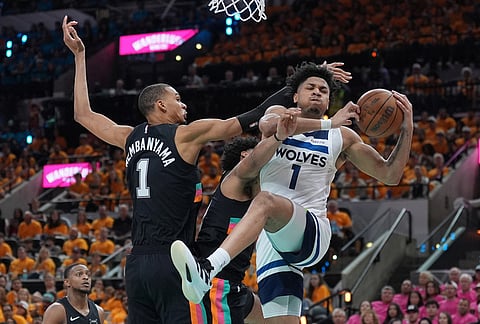 Minnesota Timberwolves guard Terrence Shannon Jr. (1) handles the ball as San Antonio Spurs forward Victor Wembanyama (1) defends during the second half in Game 1 of a second-round NBA playoffs basketball series in San Antonio.