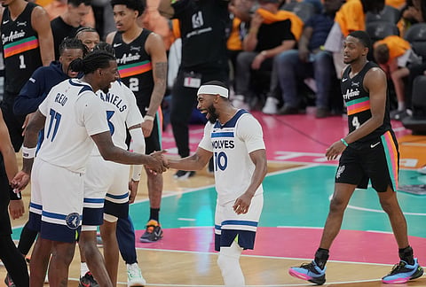 Minnesota Timberwolves center Naz Reid (11) and guard Mike Conley (10) celebrate during the second half in Game 1 of a second-round NBA playoffs basketball series against the San Antonio Spurs in San Antonio.