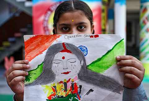 A school student displays a painting depicting 'Operation Sindoor' ahead of its anniversary, in Jammu.