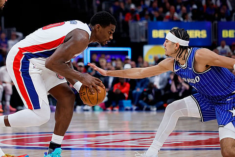 Detroit Pistons center Jalen Duren, left, drives against Orlando Magic guard Anthony Black during the first half in Game 7 of a first-round NBA basketball playoffs series in Detroit.